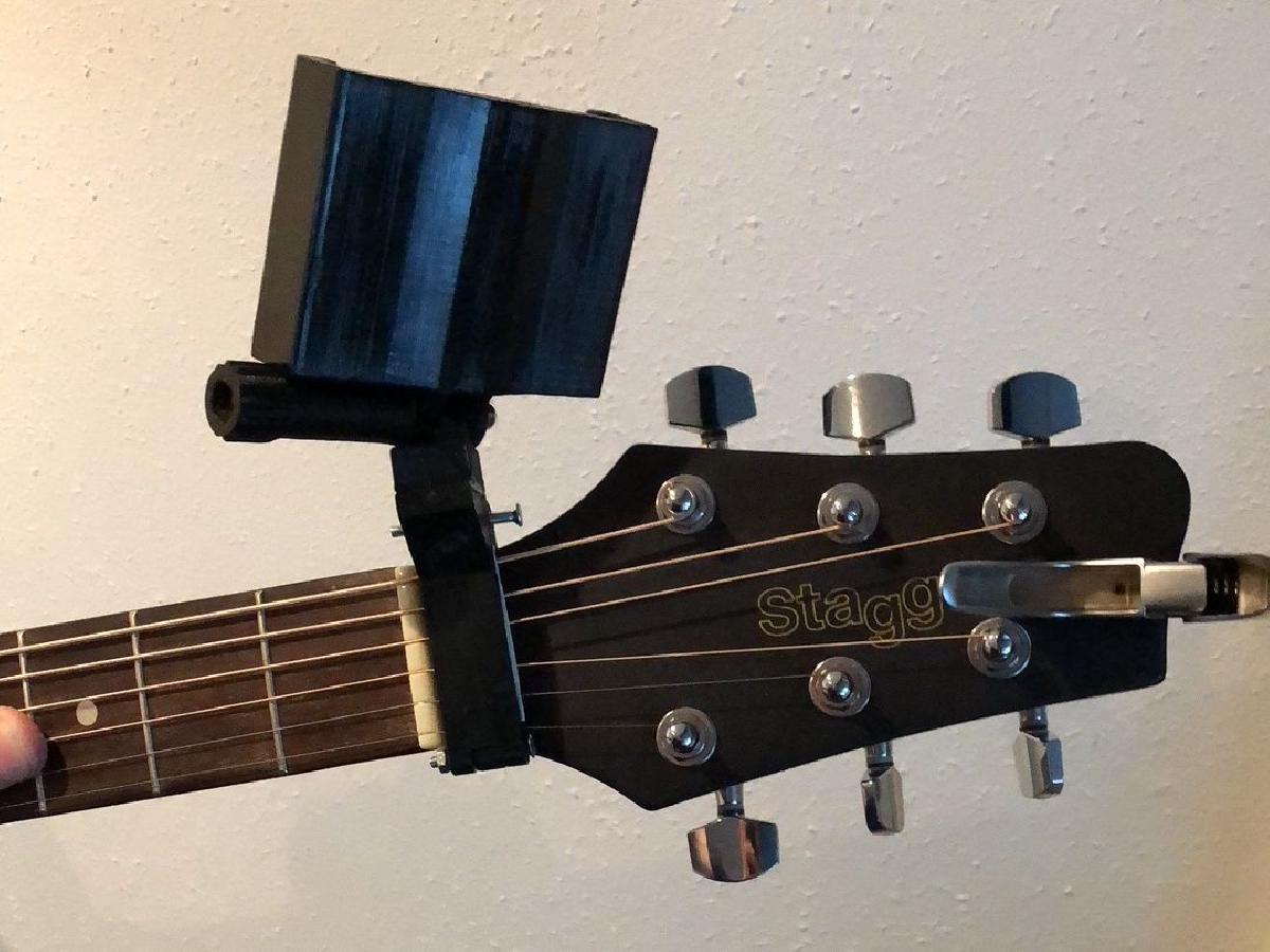 Suporte para telefone em formato de braco de guitarra