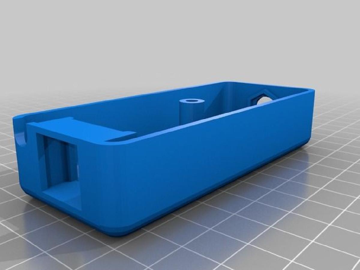 Caixa de parede de montagem saliente para um conector coaxial F e uma tomada trapezoidal