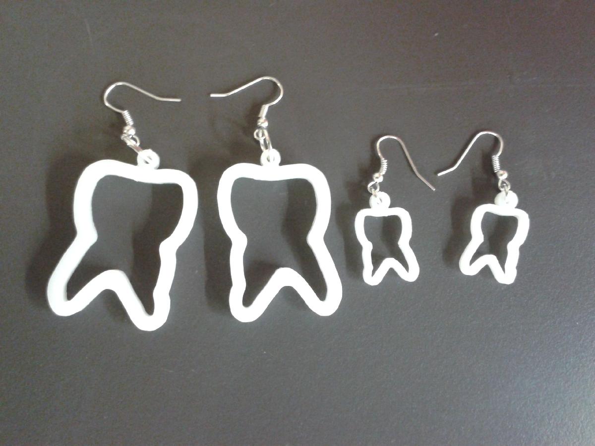 Brincos em forma de dente